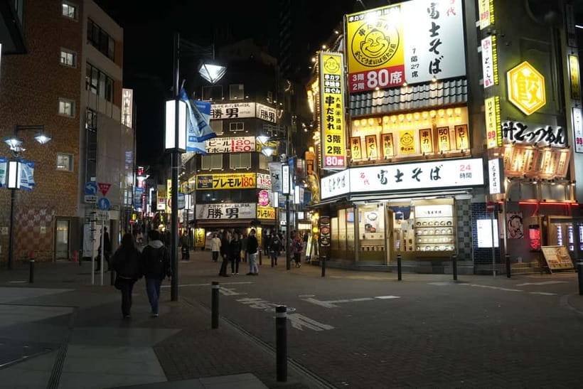 Tokyo: Shibuya Food Tour, Neon Lights & Local Flavors - Center Gai energy: snacks, neon lanes, and a 10-yen keepsake